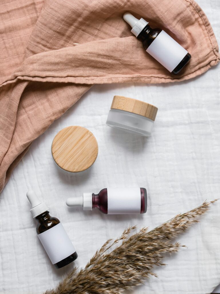 aerospace Stylish flat lay of serum bottles and jars on soft fabric with a natural, earthy aesthetic.